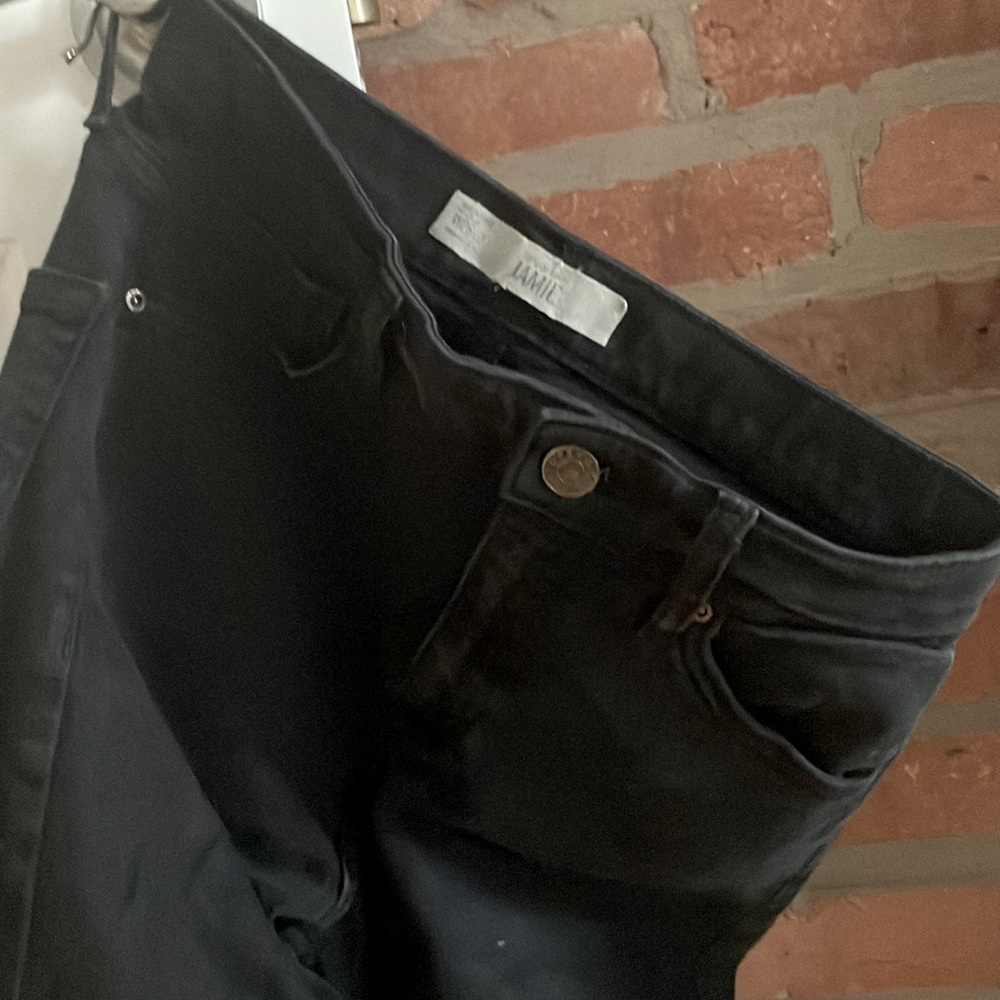 Top shop black high waisted skinny jeans with raw hem at the bottom. Cut small